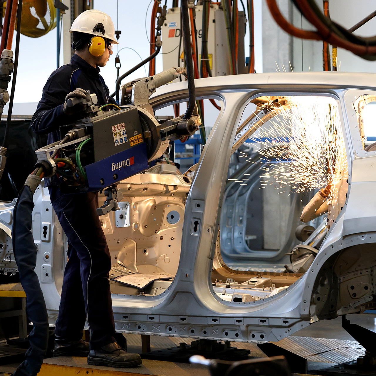 Factory worker works on the body of a BMW vehicle