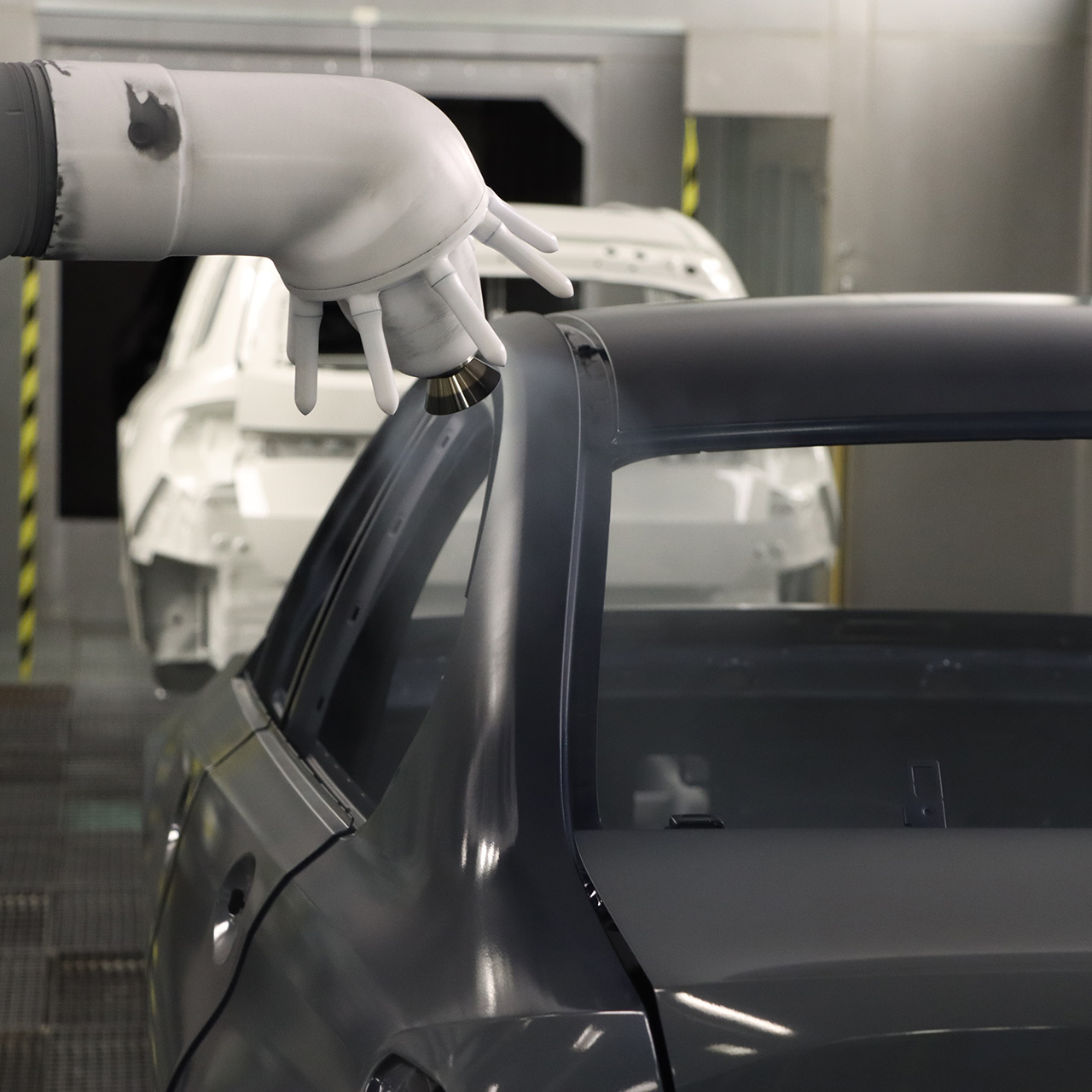 Robot arm paints the body of a BMW vehicle