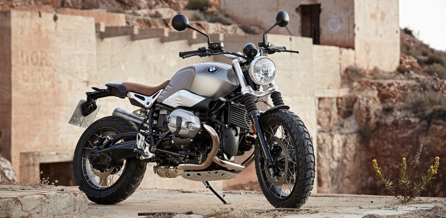 A motorcycle is parked on a rugged hilltop.