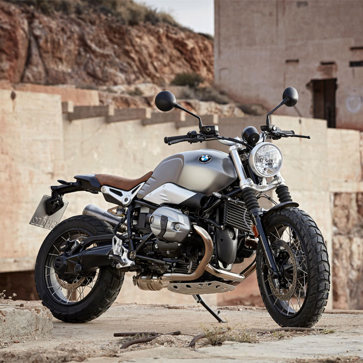  A motorcycle is parked on a rugged hilltop.