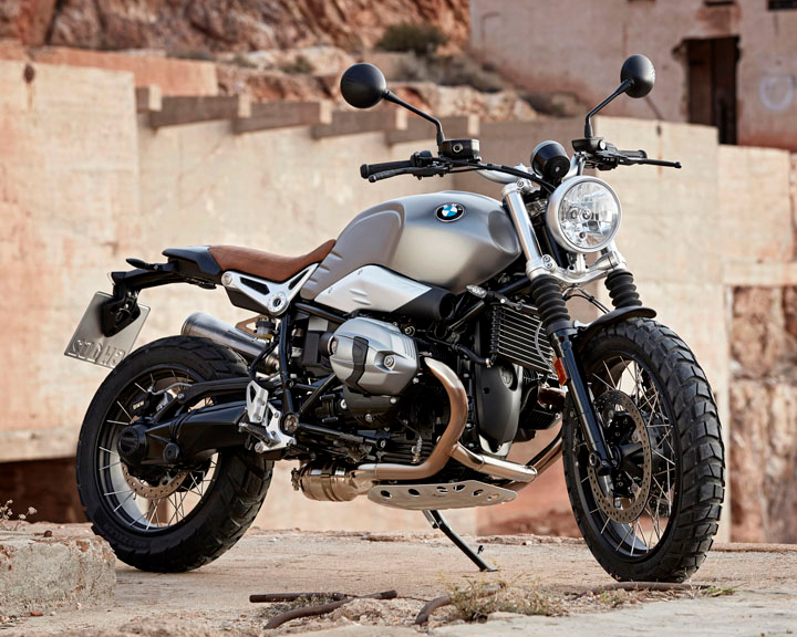  A motorcycle is parked on a rugged hilltop.