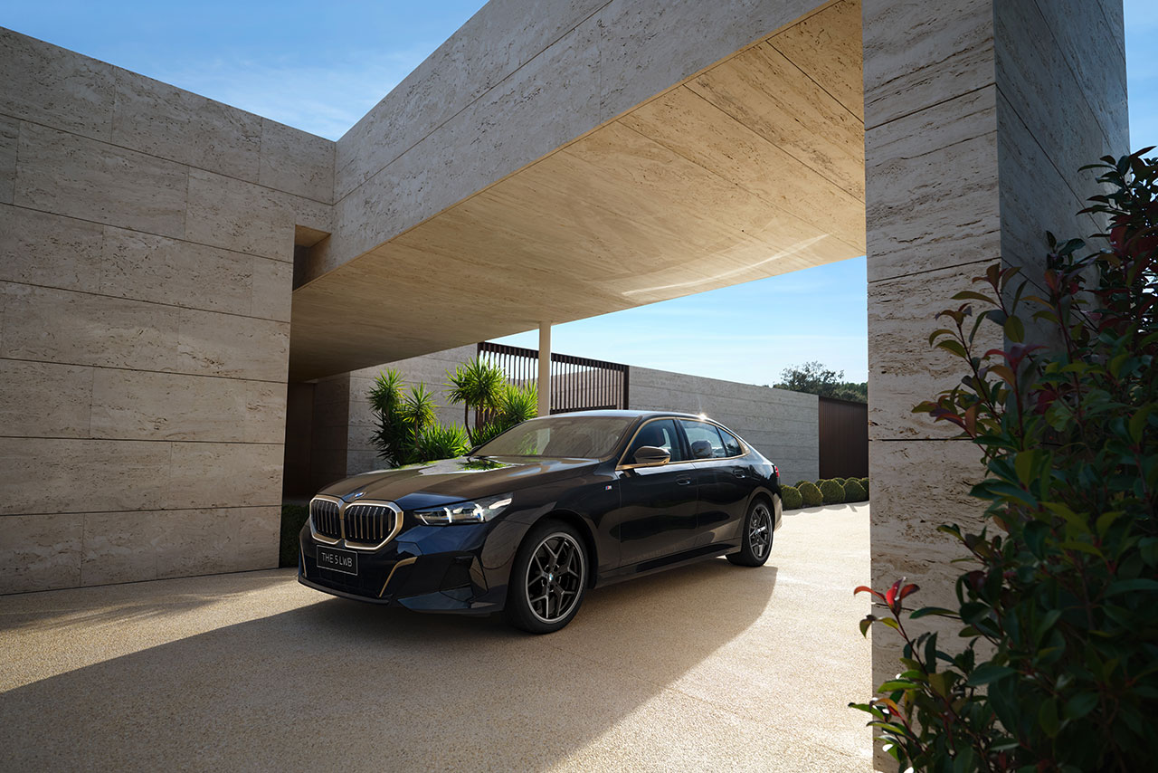BMW 5 Series in front of a modern building