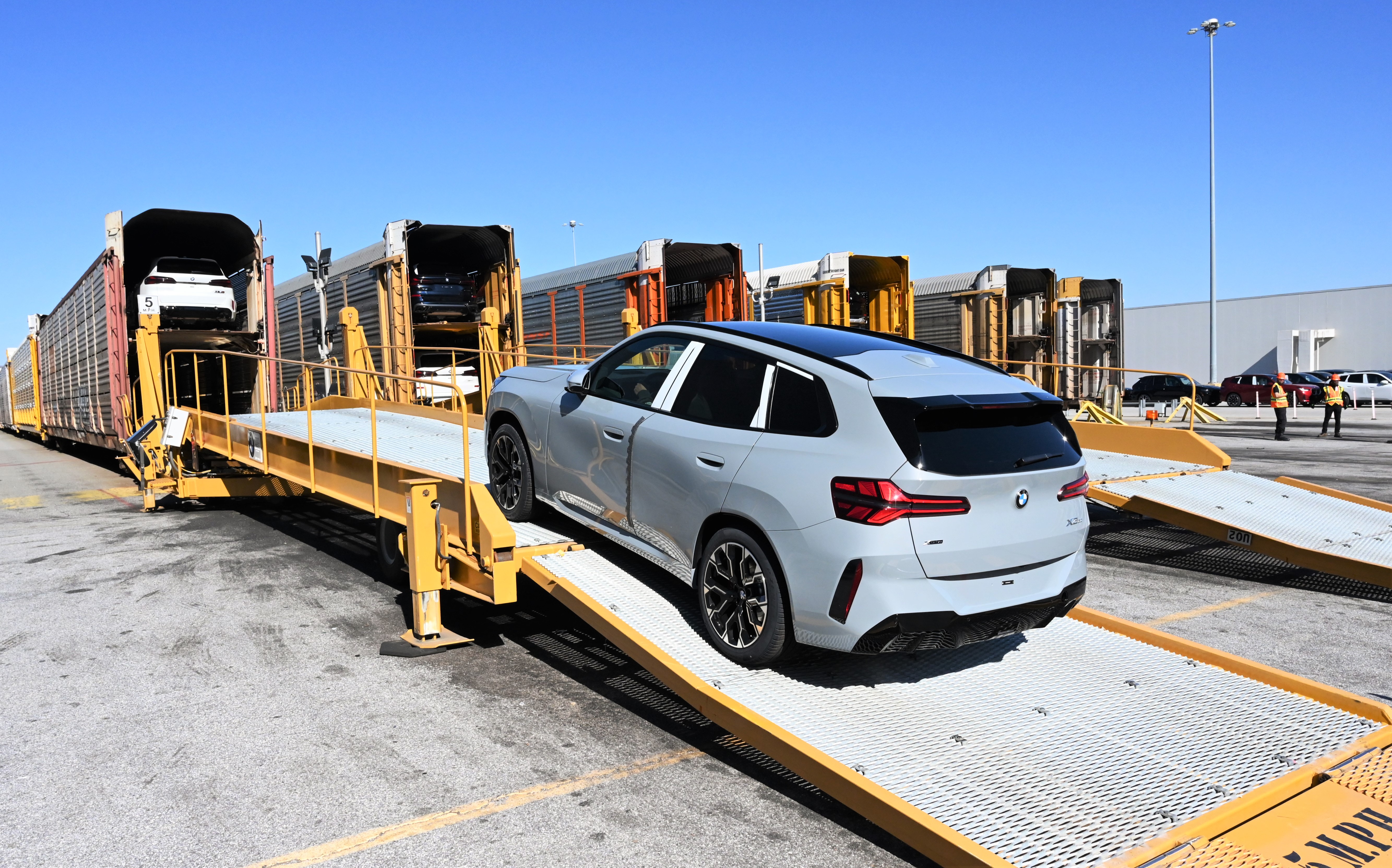 BMW X3 loading a car onto a train