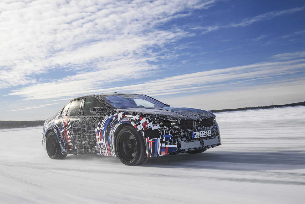 A camouflaged prototype of the latest-generation BMW M undergoes dynamic winter testing on an icy track.