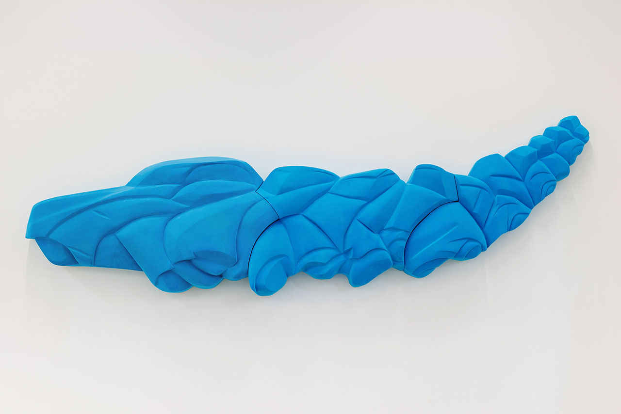 Multi-articulated blue sculpture in elongated form