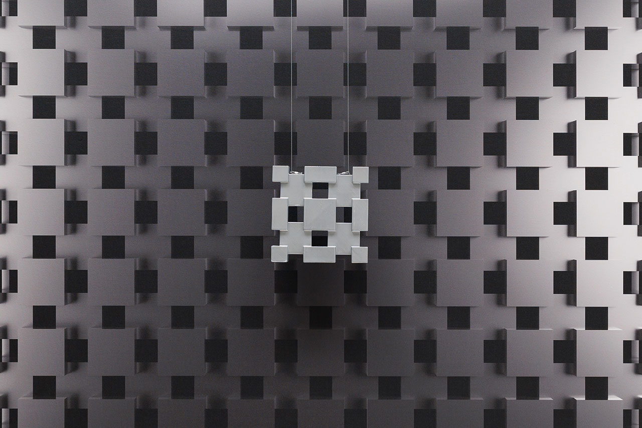 Decorative wall panels made of perforated sheet metal in various shades of grey