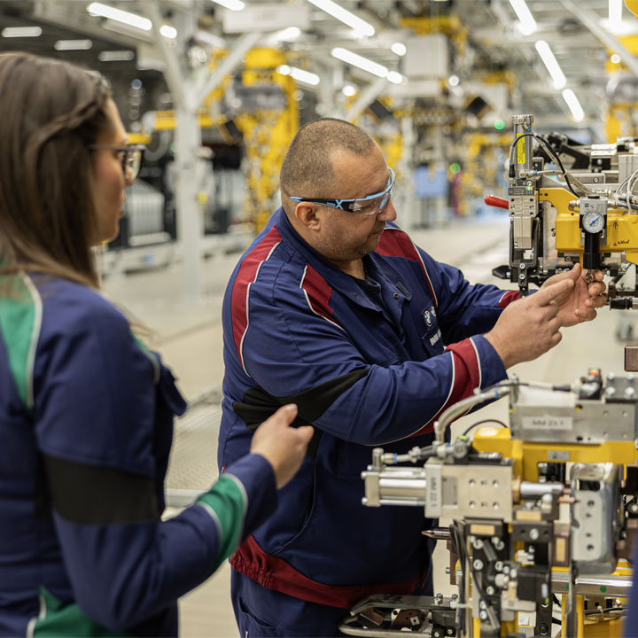 A man dressed in a blue jacket, looking directly at the camera with a relaxed demeanor.