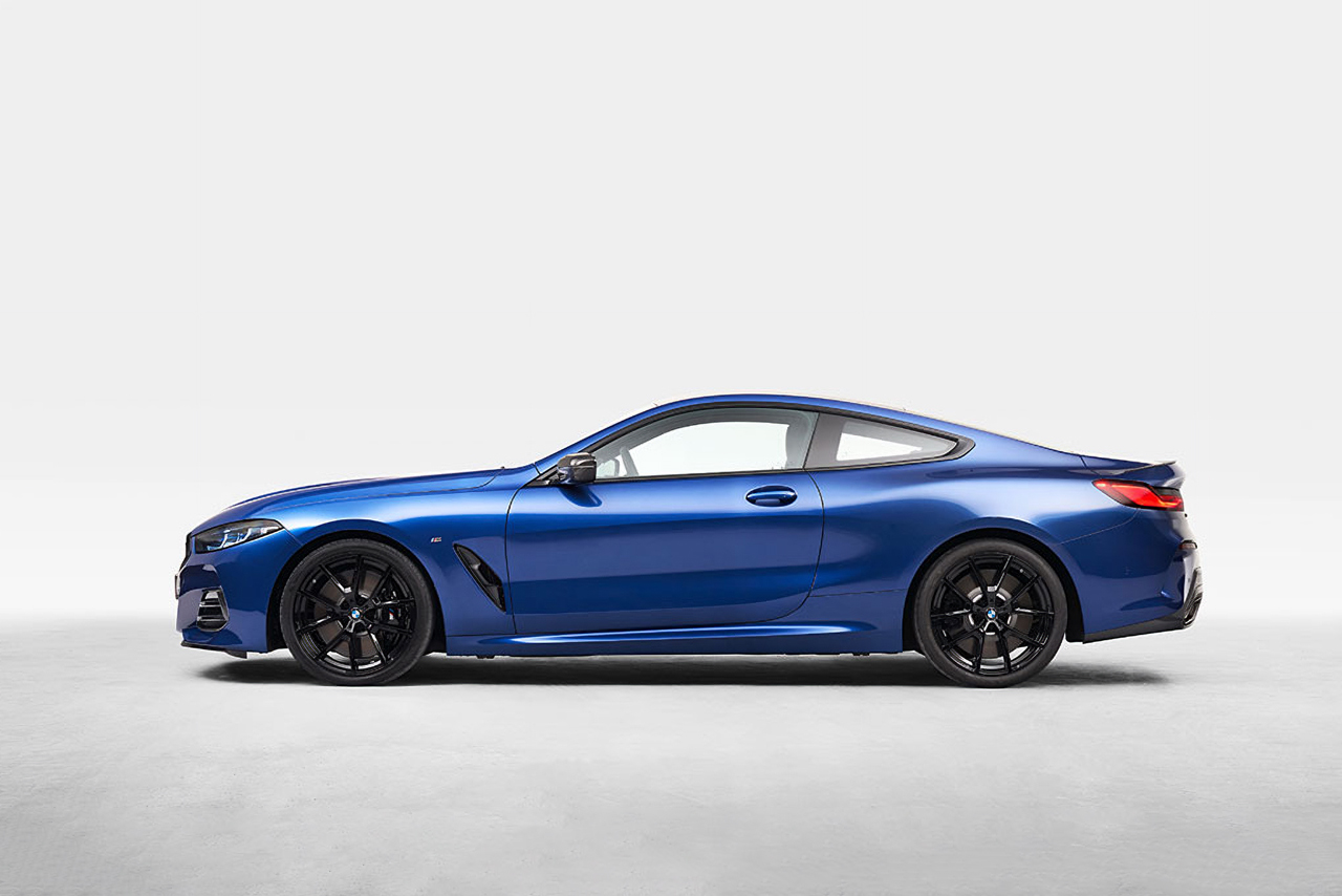 Blue BMW M8 Coupe standing in a white room.