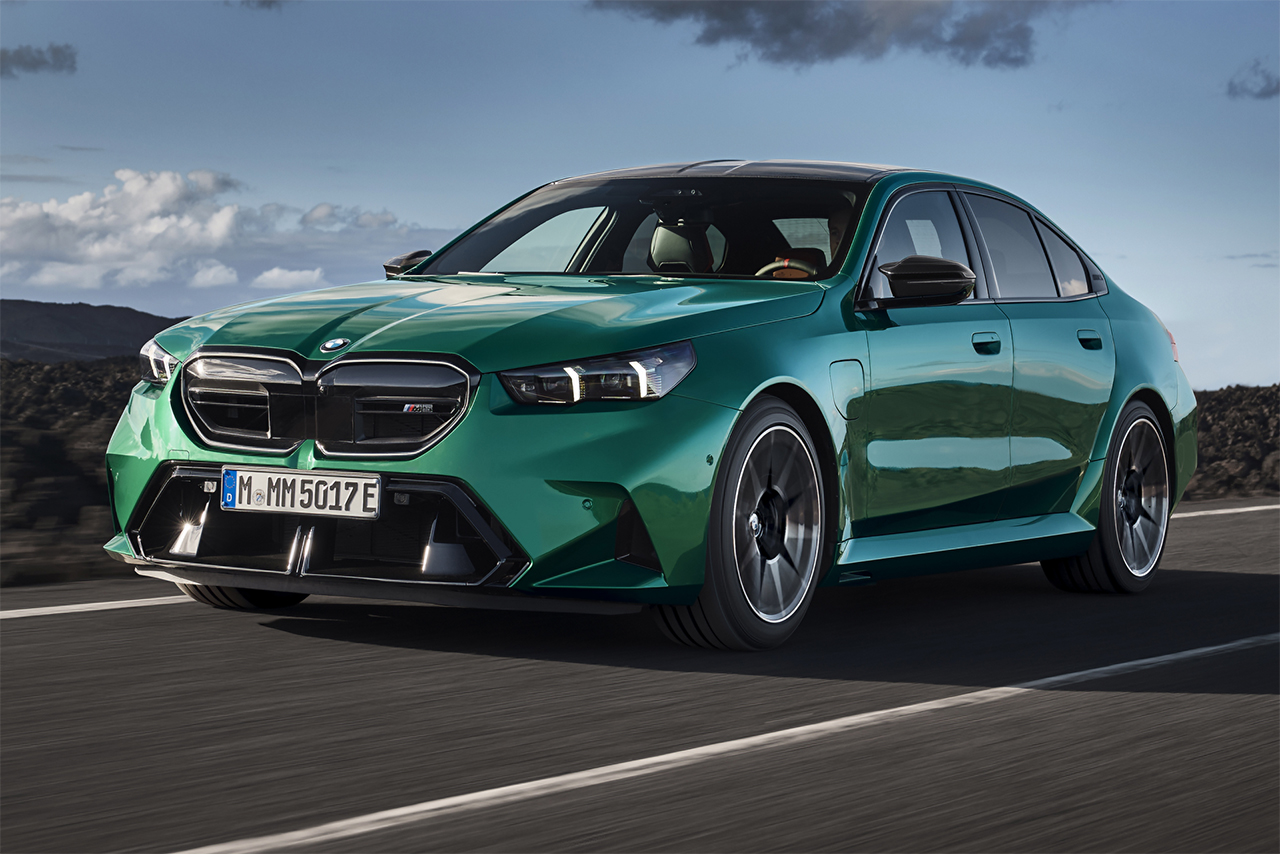 BMW M5 in Isle of Man green drives through nature.