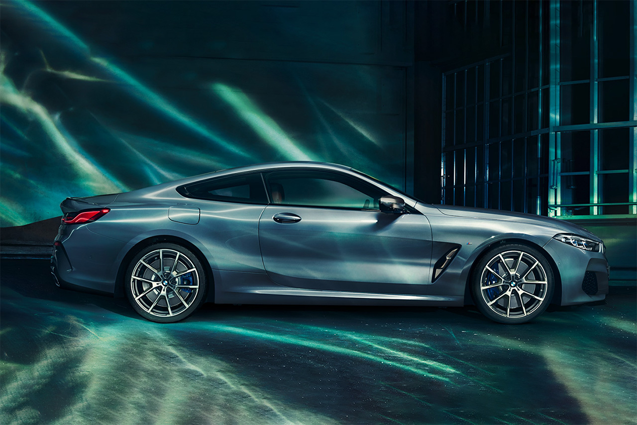 BMW 8 Series in a room with water reflections above.
