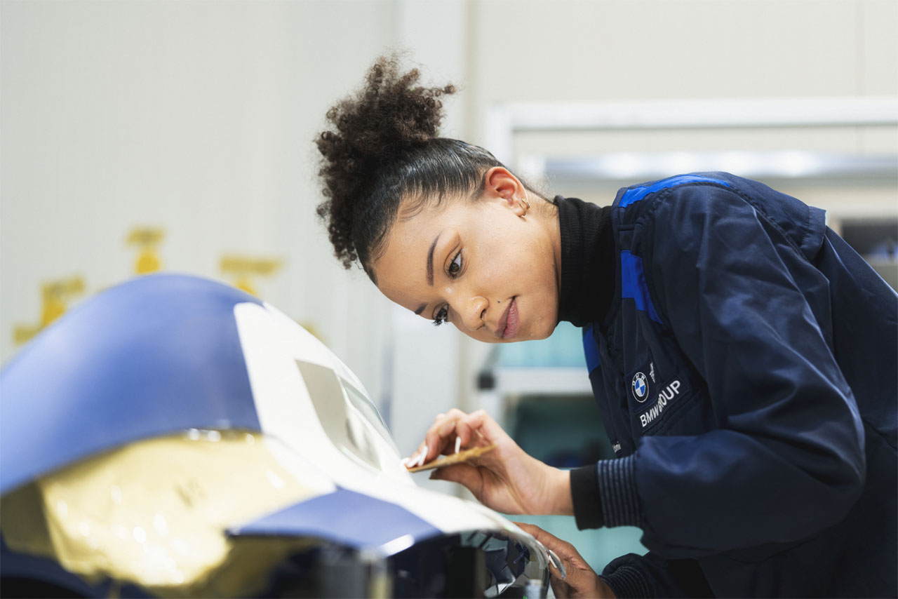 A plastics specialist who works meticulously on the details of a vehicle.