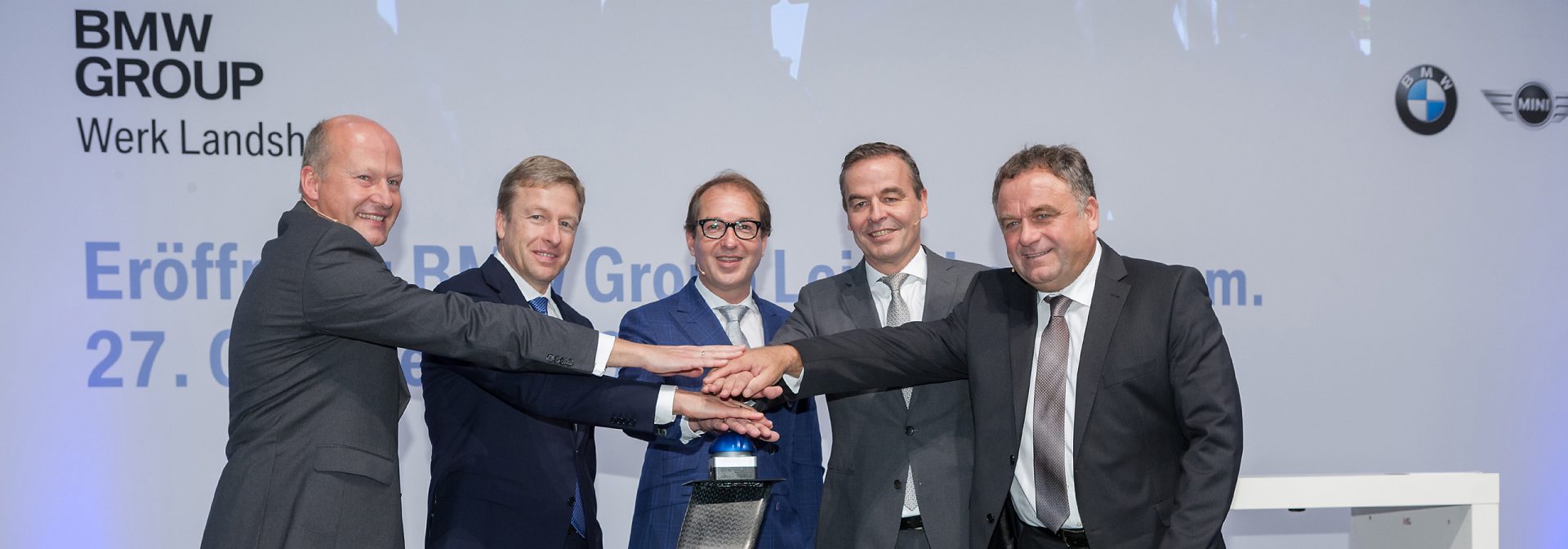 People demonstratively press a start button