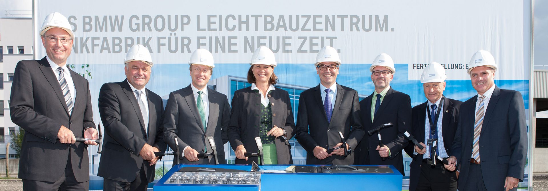  Opening of the BMW Group Lightweight Construction Center with executives wearing hard hats.