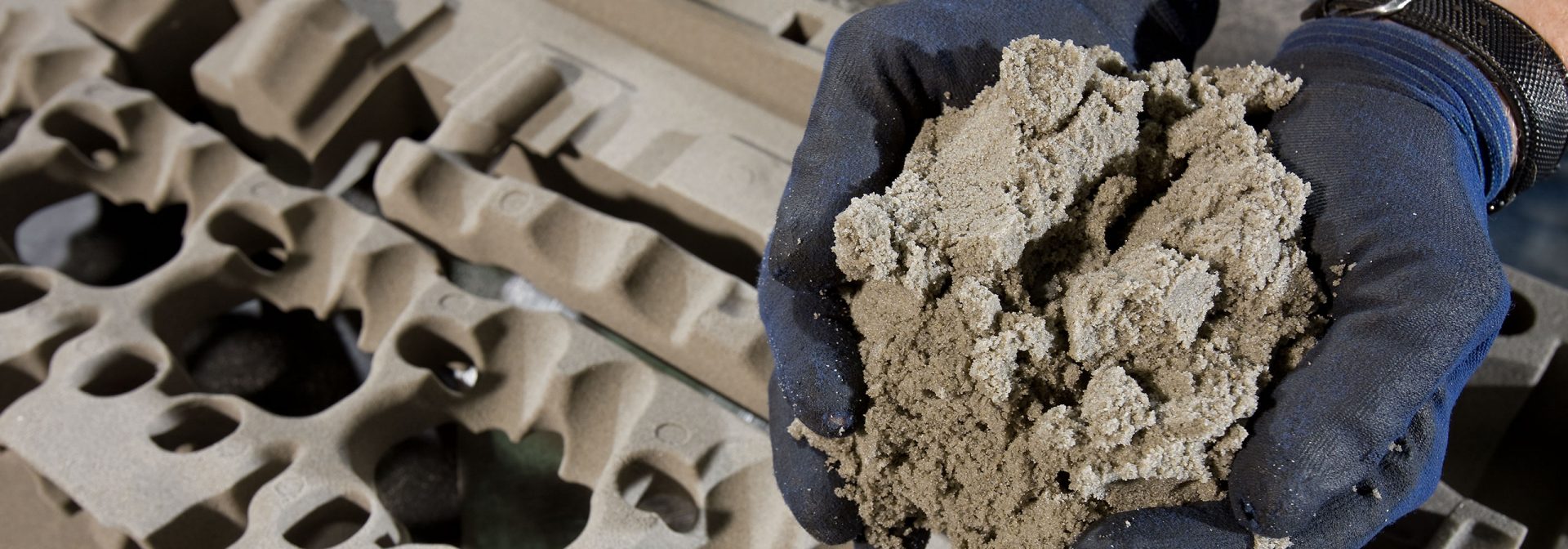 Hands holding earth in front of a camera