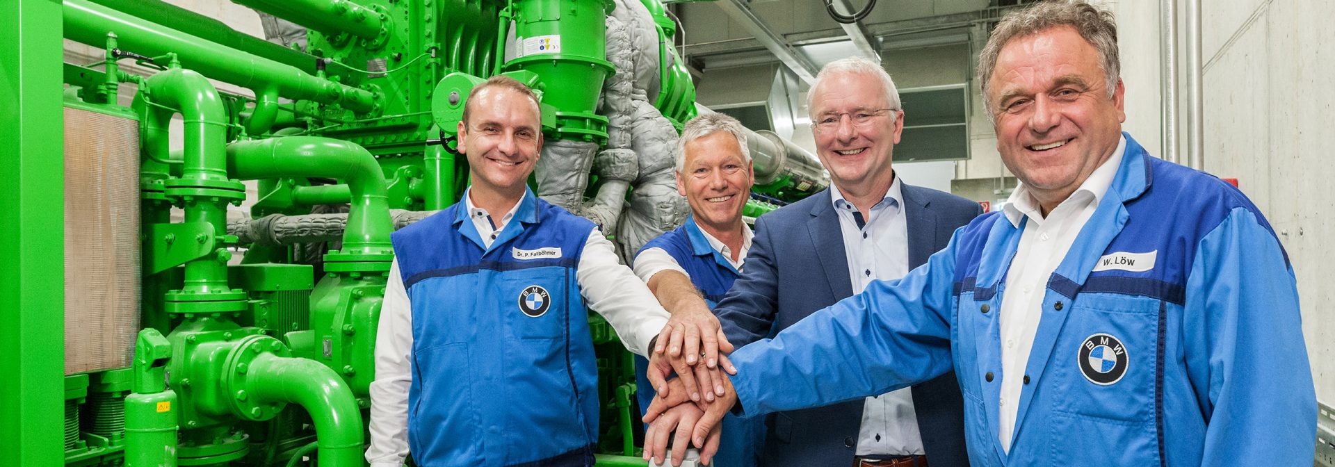 People press the start button for the plant's highly efficient combined heat and power plant