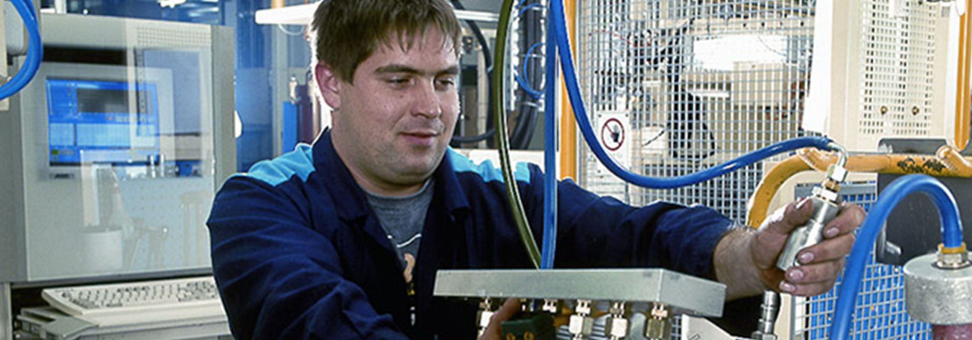 Factory workers in replacement engine production