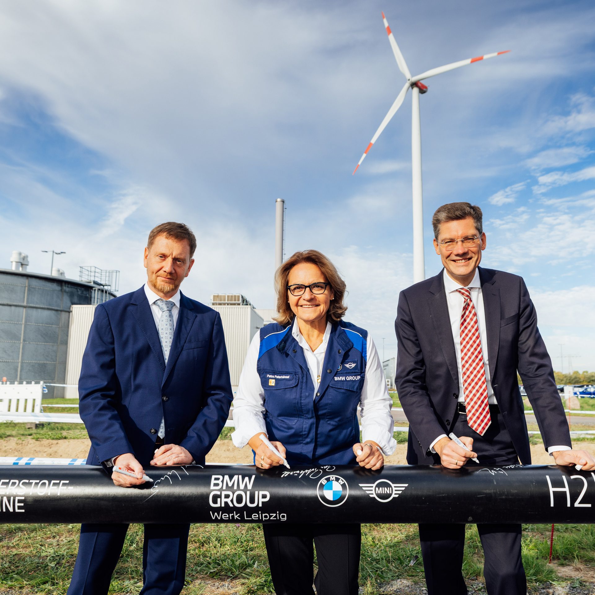 3 people standing at a Hydrogen pipeline construction yard