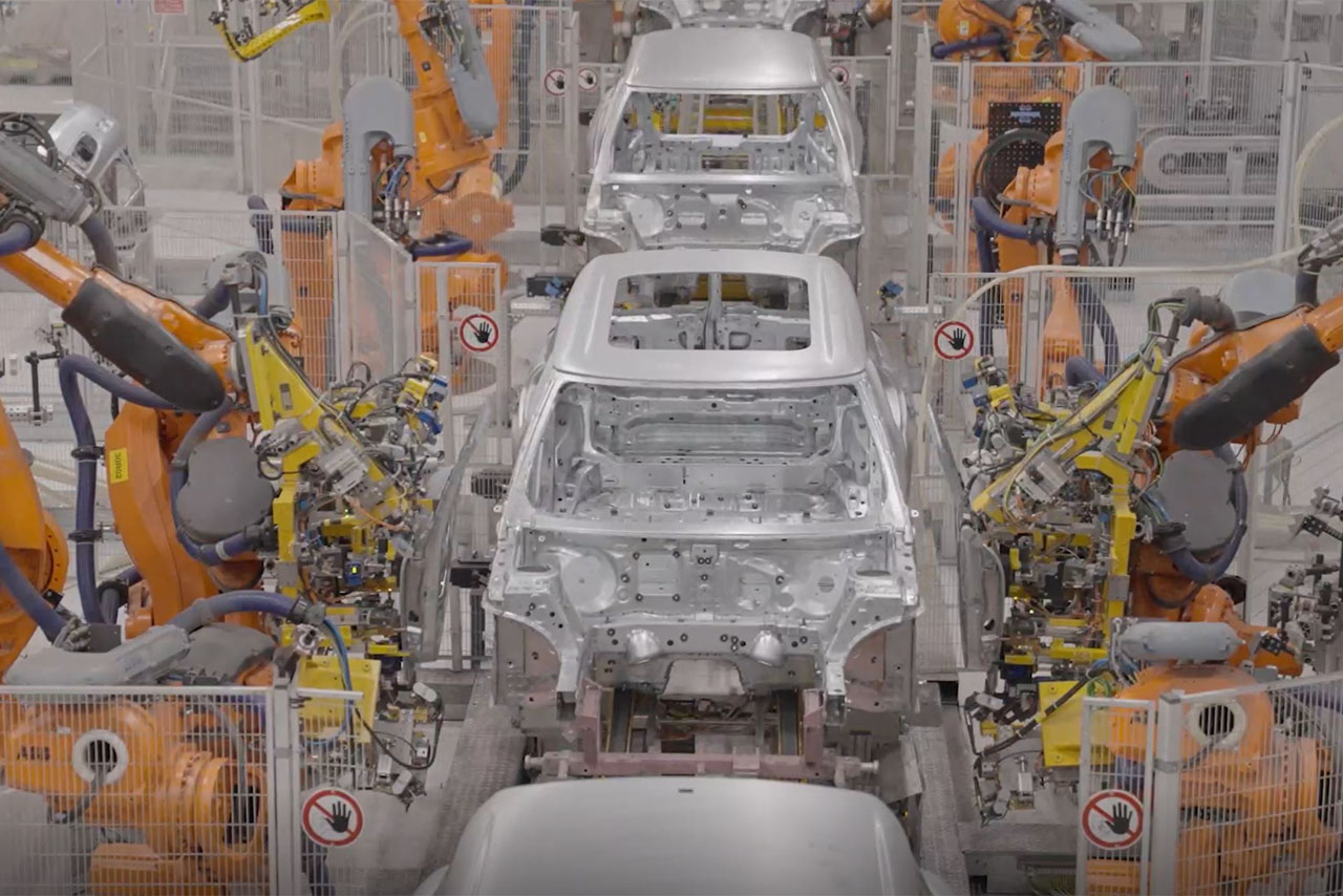  Robots assemble cars on an assembly line, showcasing advanced automation in vehicle manufacturing.