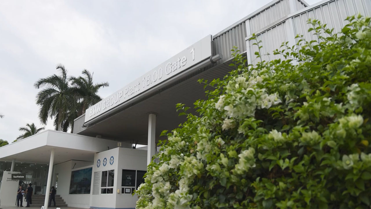 The building entrance features a white and green color scheme, creating a welcoming appearance.