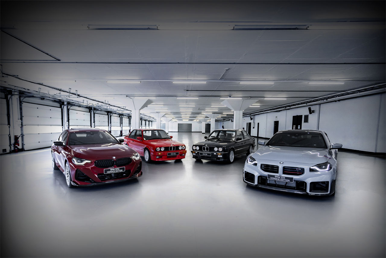 Four BMW cars in a bright, spacious garage, two red, one black, and one silver, shown from front and side angles.