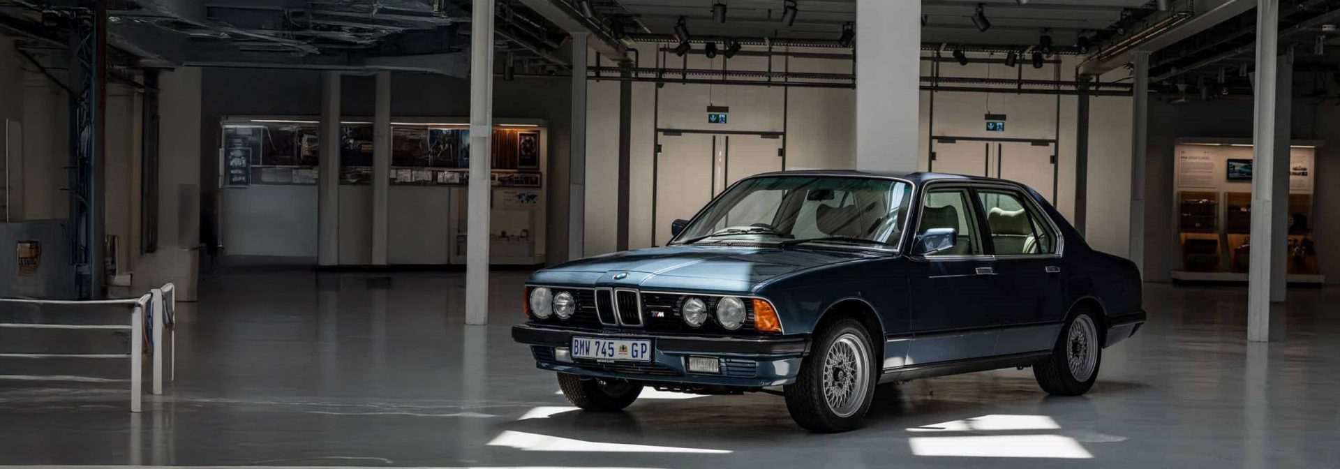 Restored BMW 7 showcasing its classic design and vibrant paint, highlighting meticulous craftsmanship and attention to detail.