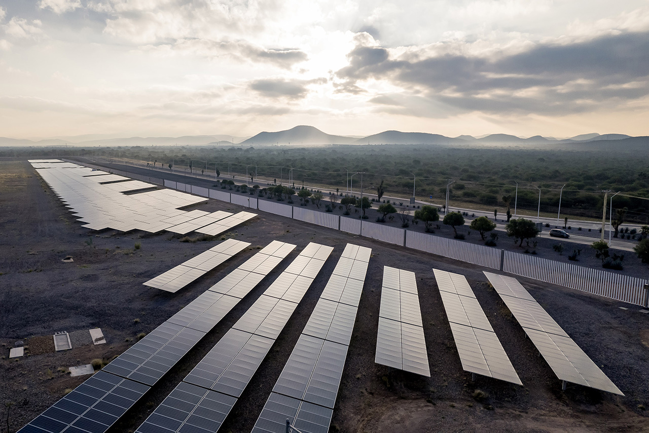 Solar cells from a bird's eye view with mountains in the background
