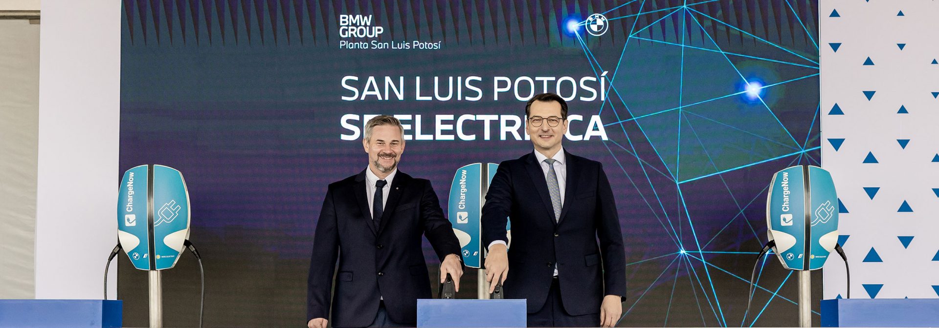 Two board member of the BMW Group standing on a stage.