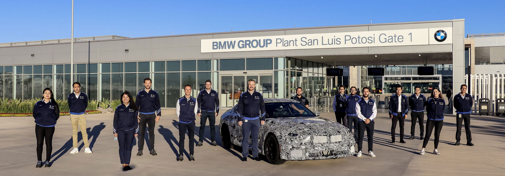 The BMW team posing for a group picture with the BMW M2