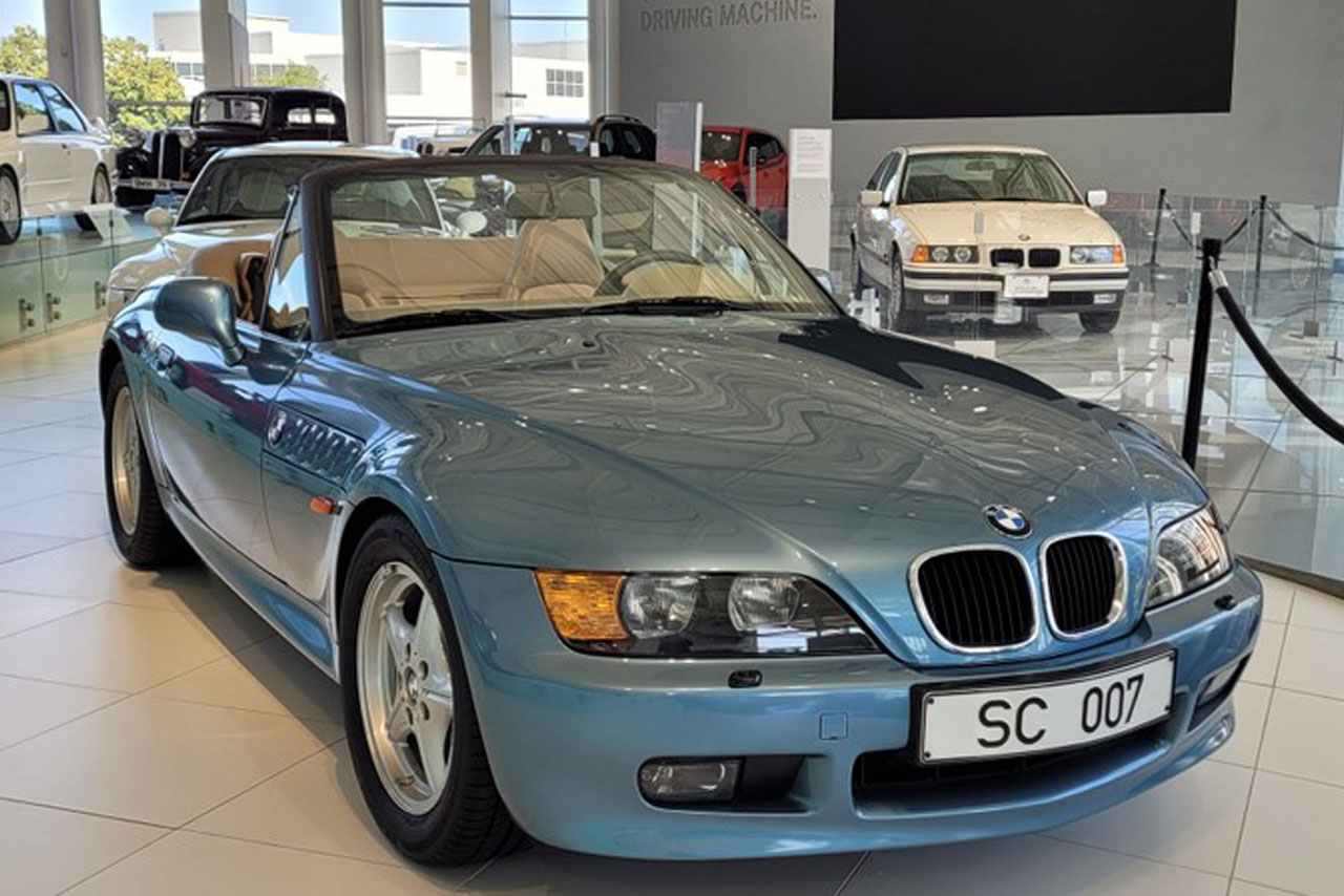 A sleek BMW Z3 roadster parked on a scenic road, showcasing its sporty design and vibrant color.