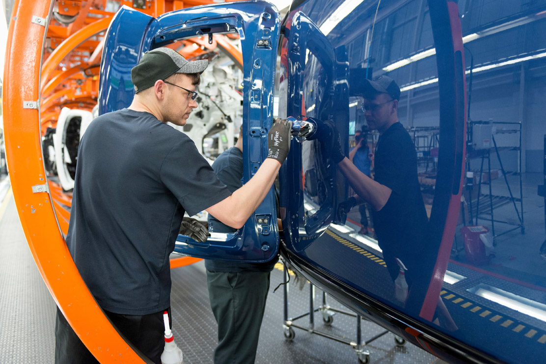 A man in Assembly putting a car together.