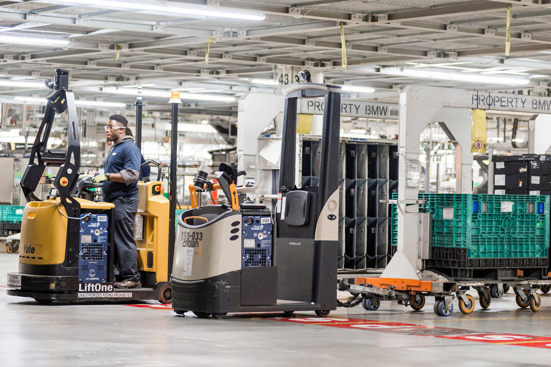 A man using a Forklift truck in the Logistics centre.