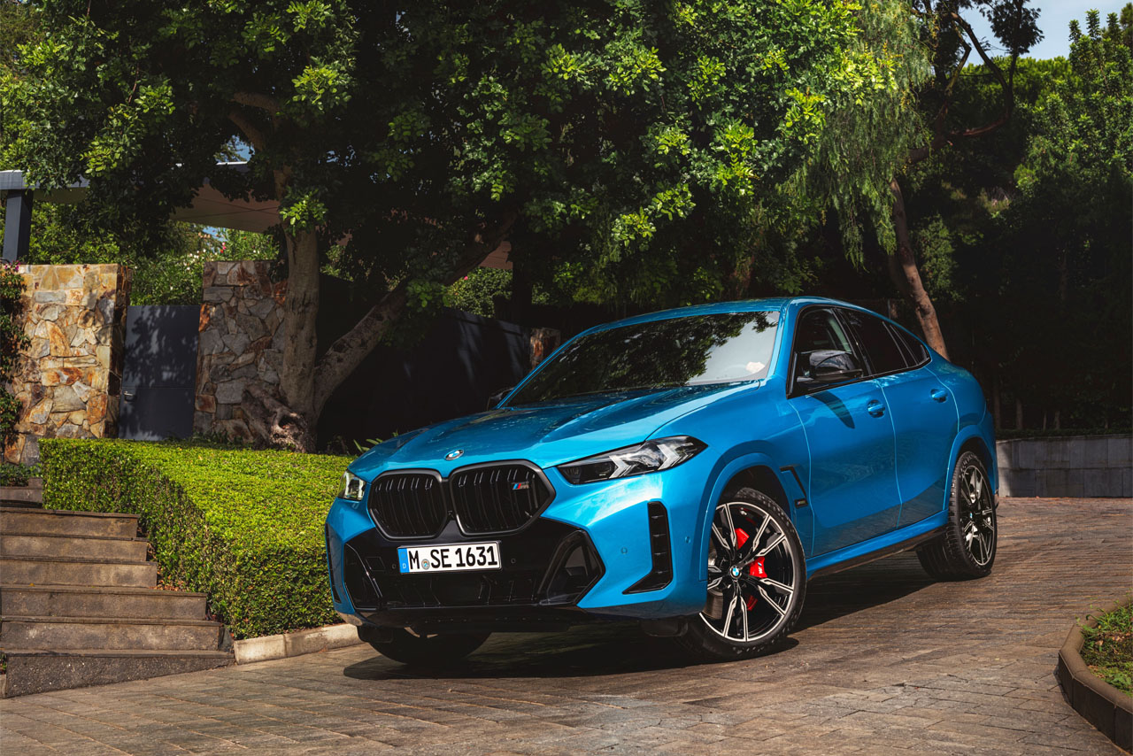 A BMW X4 parked on a driveway, showcasing its sleek design and modern features.