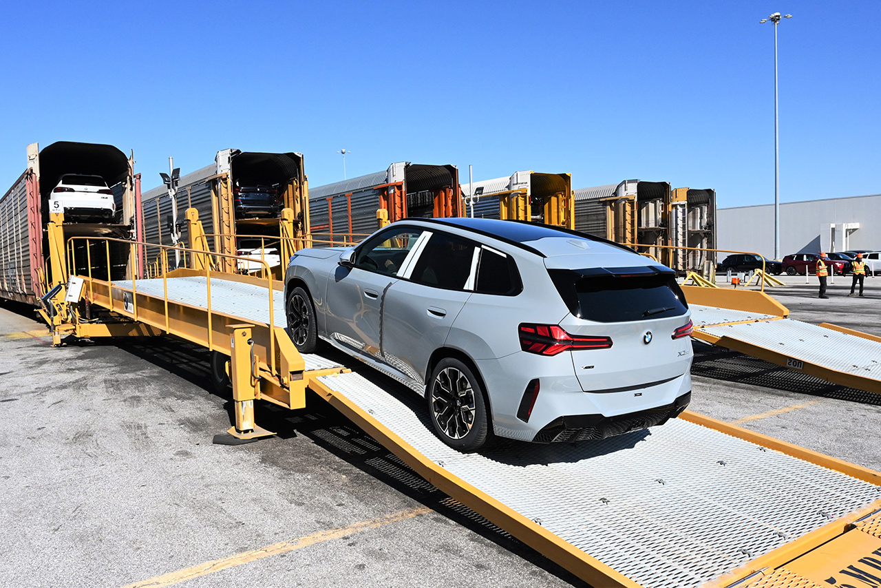 A bmw x3 is loaded onto a car train