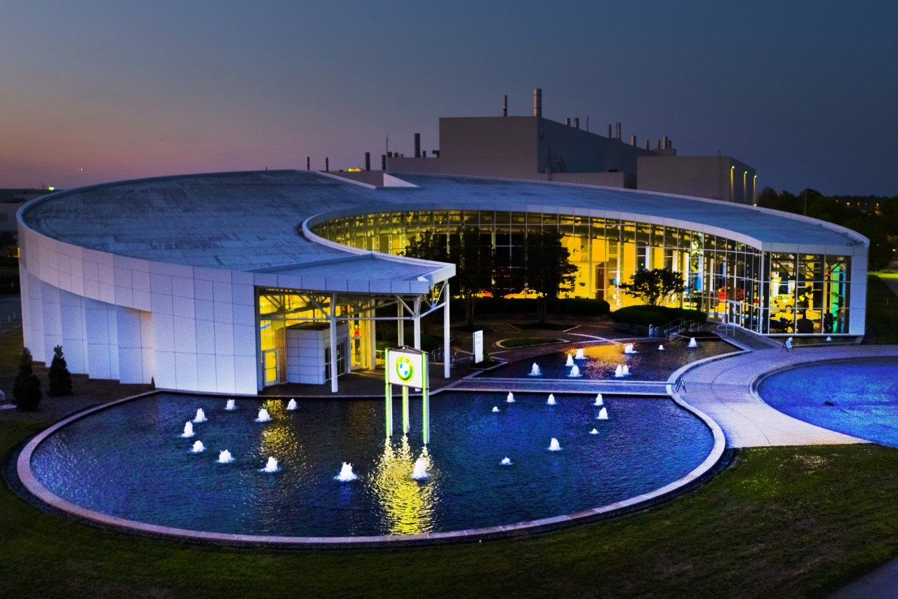 Zentrum Museum lit up at night with X display and fountain out front. 
