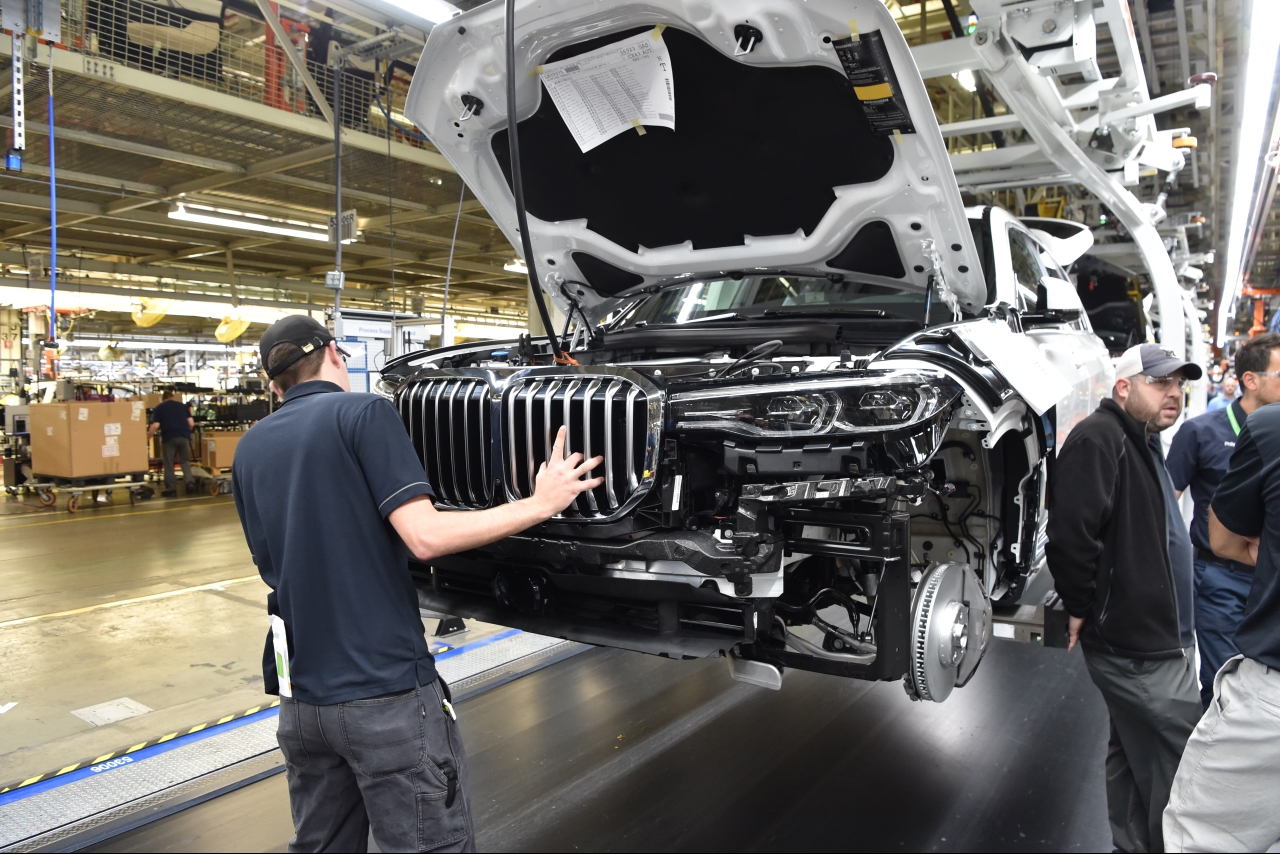 Assembly associate places the Kidney Grille on an BMW X7 pre-production model. 