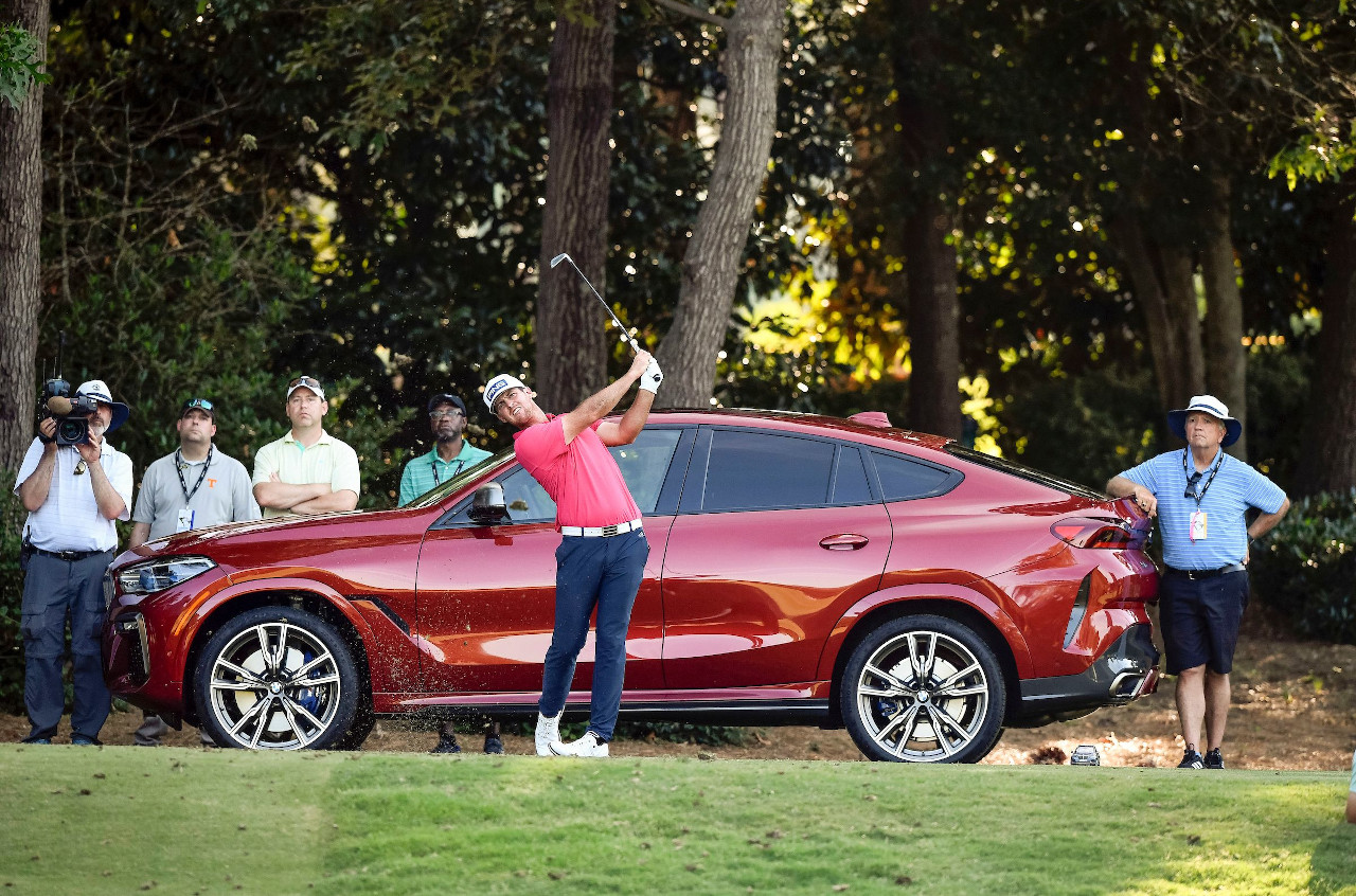 2021 BMW Charity Pro-Am champion Mito Pereira on the course with BMW X model staged behind him. 