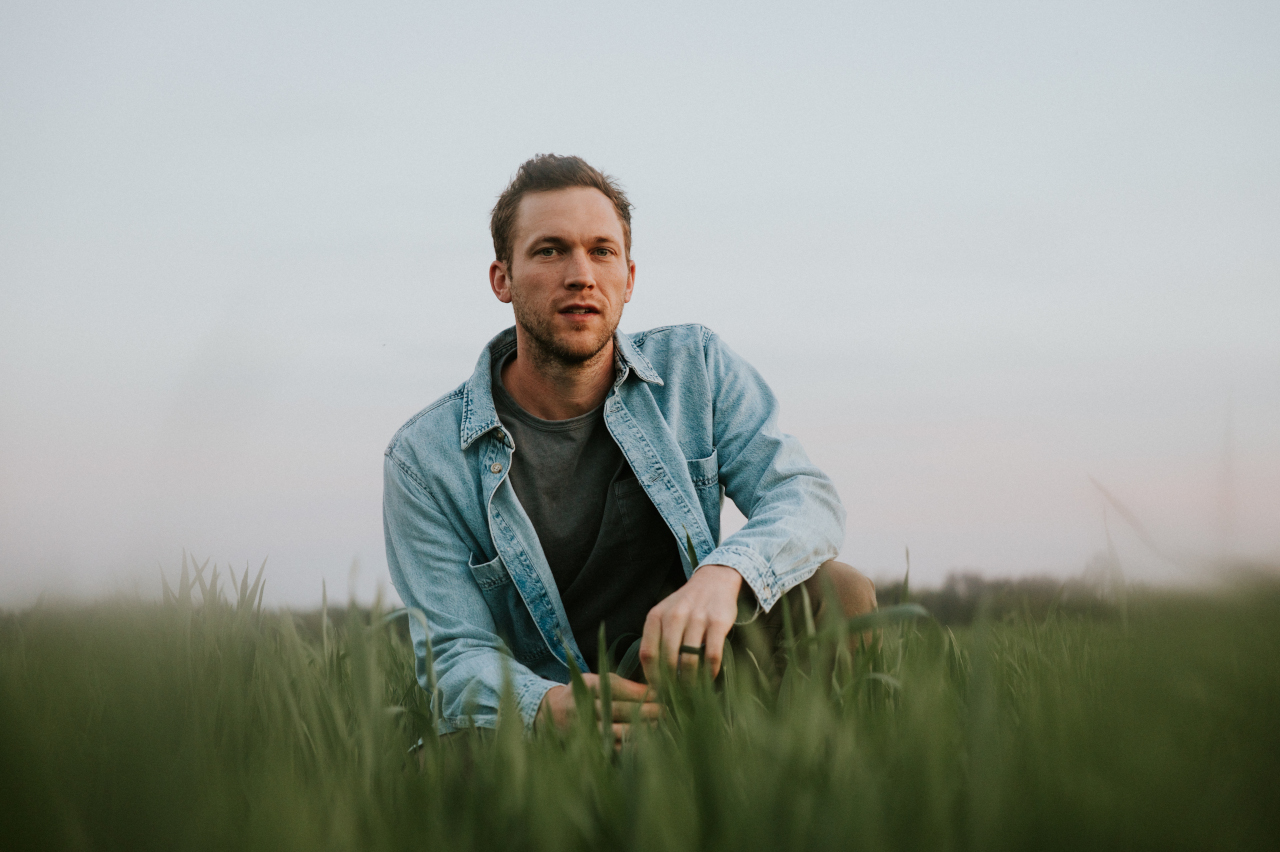 Phillip Phillips in a field. 