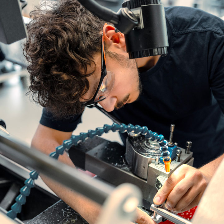  An apprentice works on vehicle parts using state-of-the-art technology.