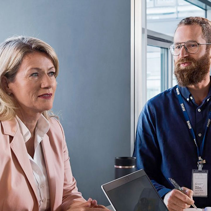  Three professionals are sitting together having a discussion.