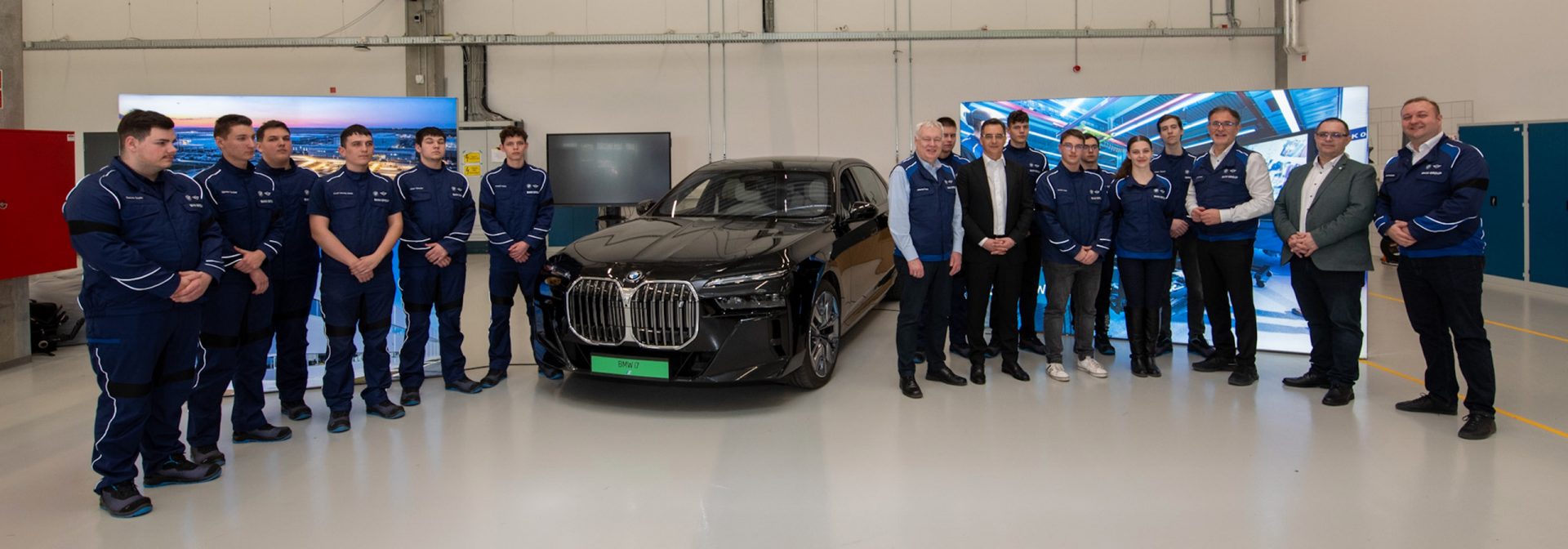 Students are standing around a bmw 7 series