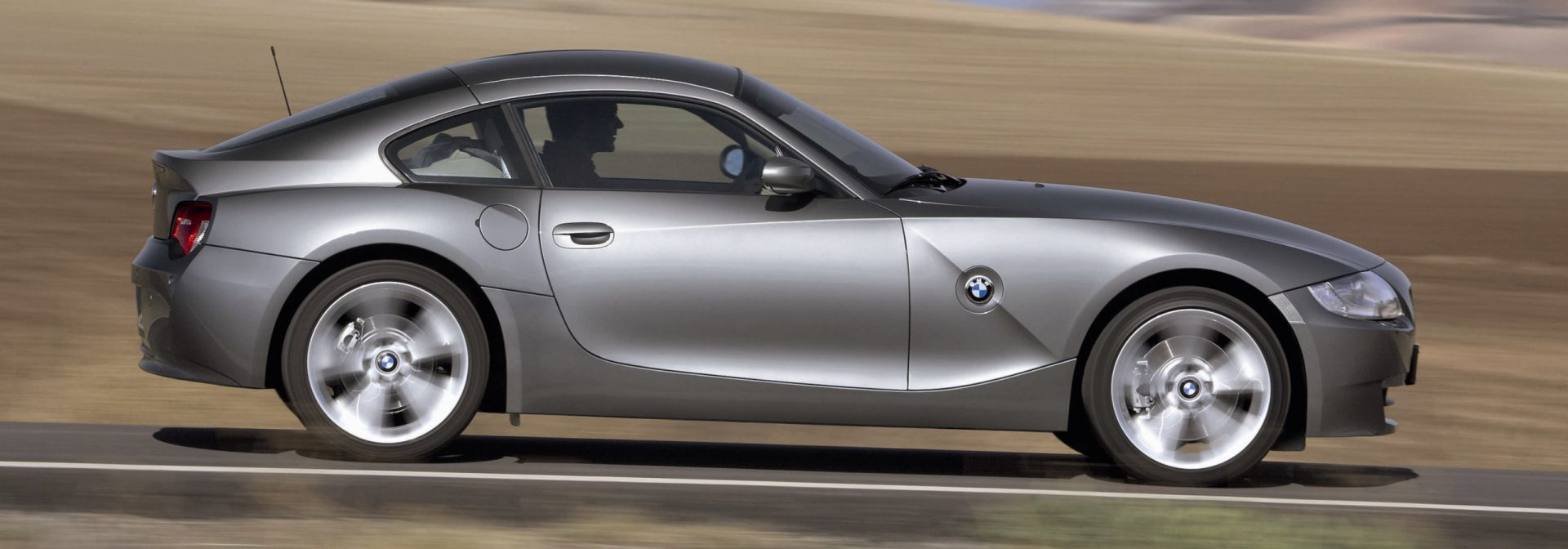 BMW Z4 Coupe and M Coupe assembly begins. Beauty shot of Z4 on the road with desert background. 
