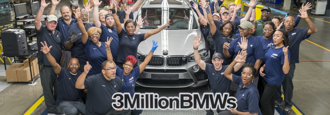 Associates on the assembly line gather around the 3 millionth vehicle. 