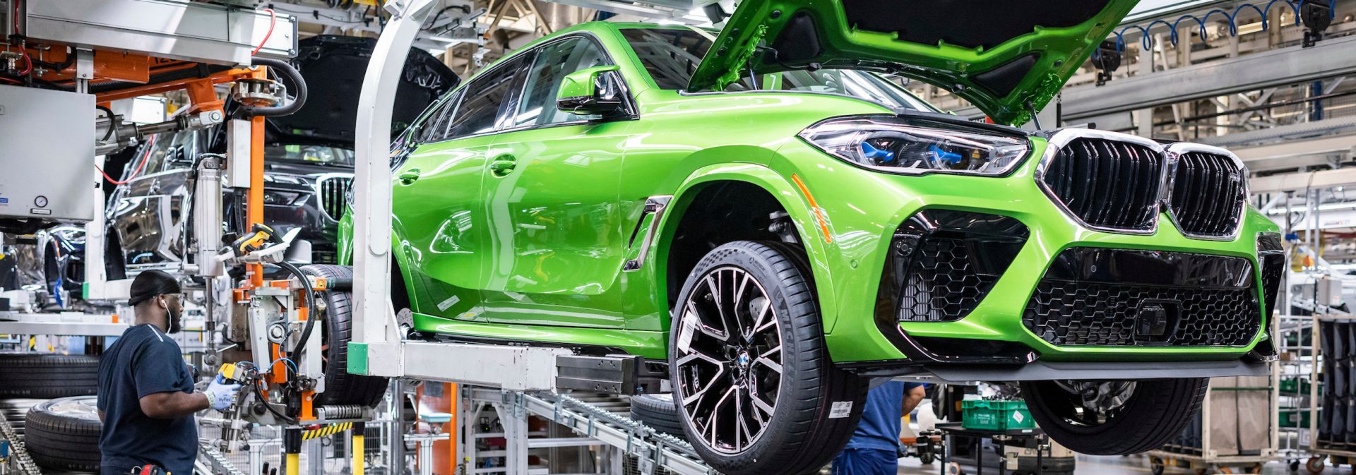 Java Green Metallic BMW X6 M on a lift in the assembly process. 